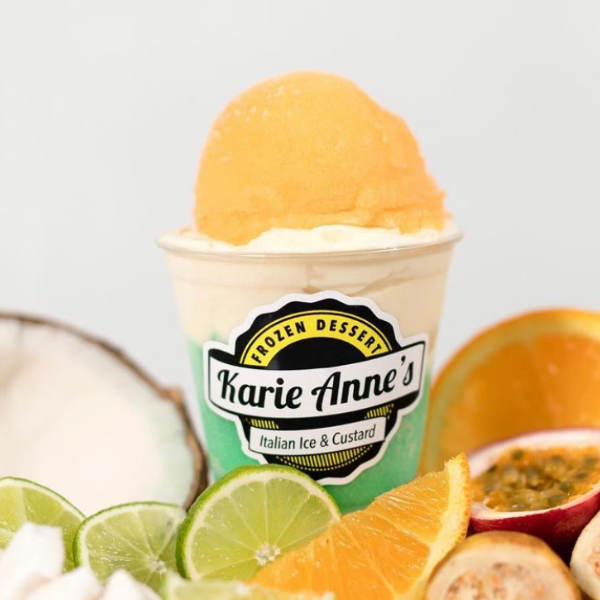 a gelati with vanilla custard and blue and orange italian ice, surrounded by citruses and a coconut